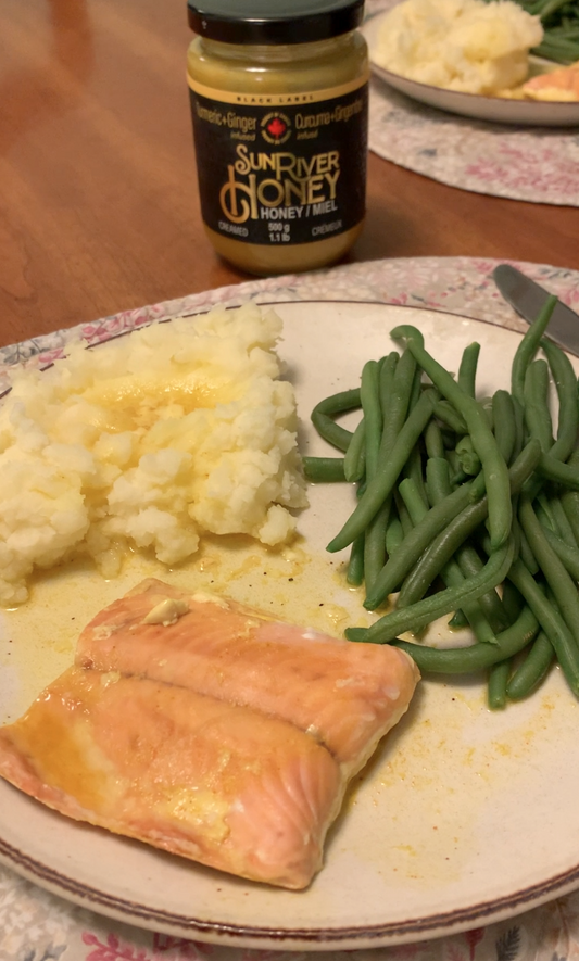 Turmeric Ginger Sun River Honey on baked salmon with mashed potatoes and green beans