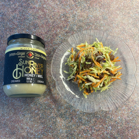 Lemon/Ginger infused Sun River Honey beside a plate of Broccoli Slaw