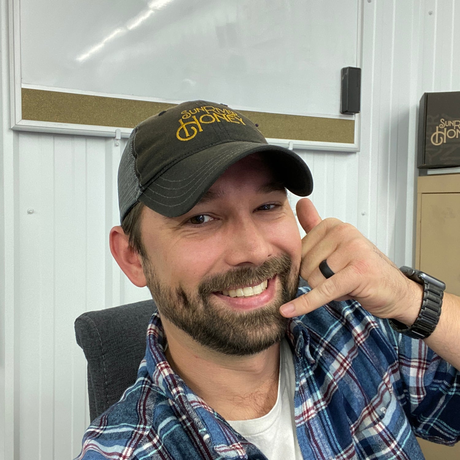 Aaron taking a phone call and smiling